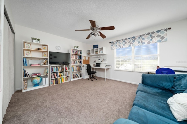 carpeted living room with baseboards, a textured ceiling, and ceiling fan