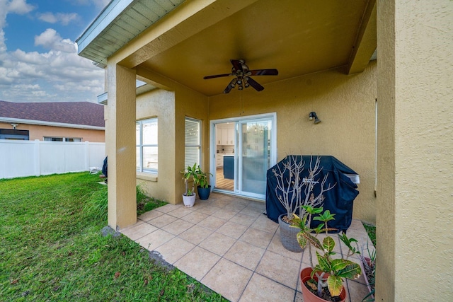 view of patio featuring a ceiling fan and fence