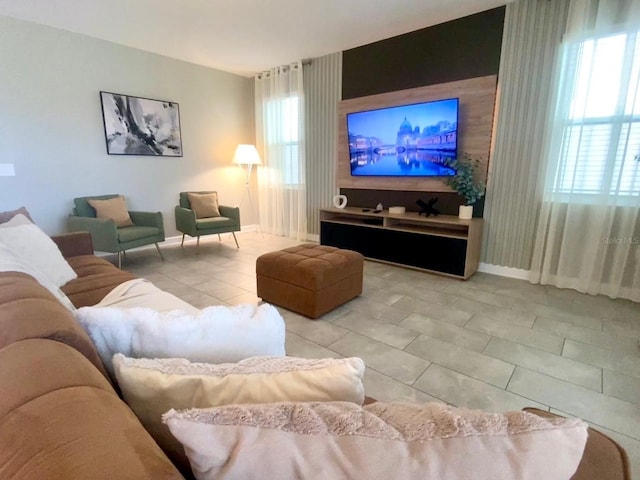 living room featuring tile patterned floors and baseboards