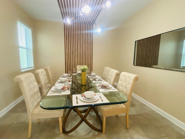 dining room with tile patterned flooring and baseboards