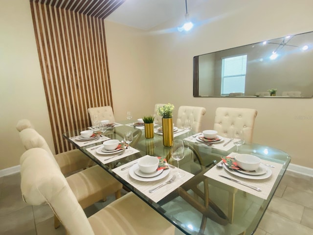 dining space featuring tile patterned flooring and baseboards