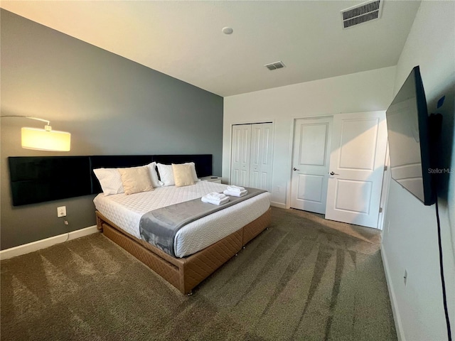 carpeted bedroom featuring baseboards, visible vents, and a closet