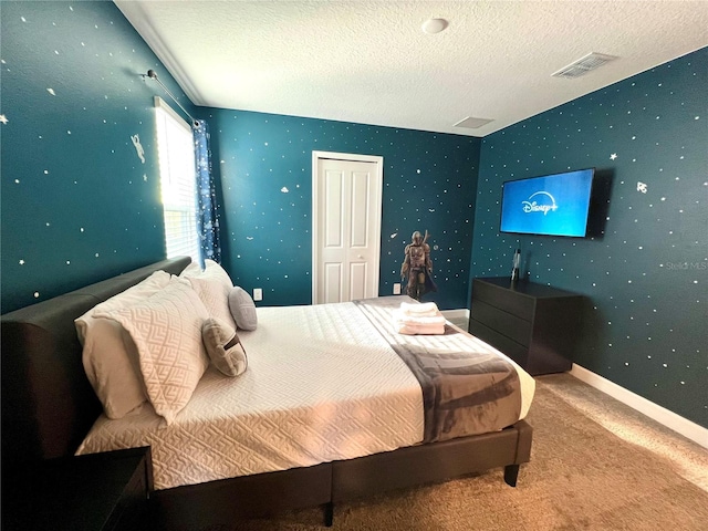 carpeted bedroom featuring wallpapered walls, baseboards, visible vents, and a textured ceiling