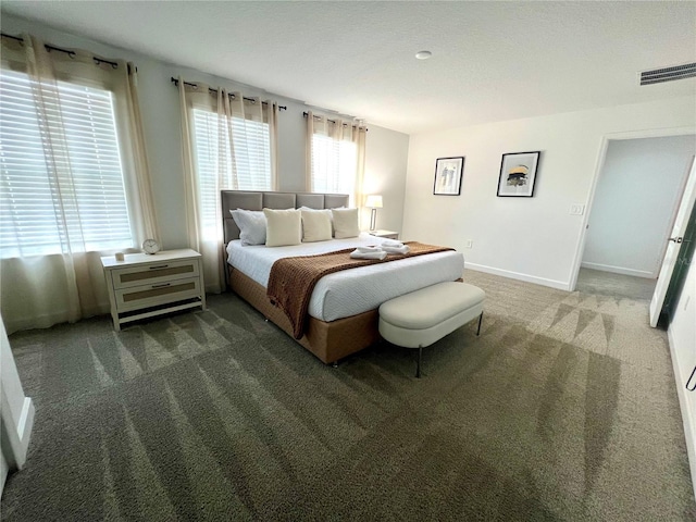 bedroom with carpet flooring, baseboards, and visible vents