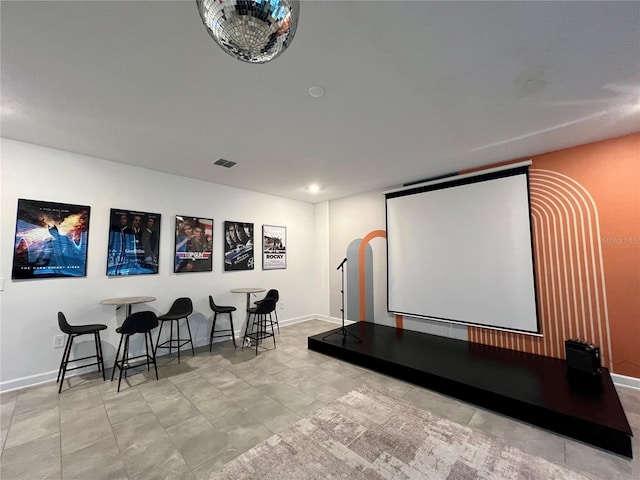 home theater featuring baseboards and visible vents