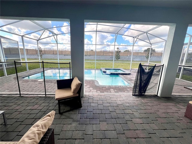 view of swimming pool featuring a lanai and a patio area