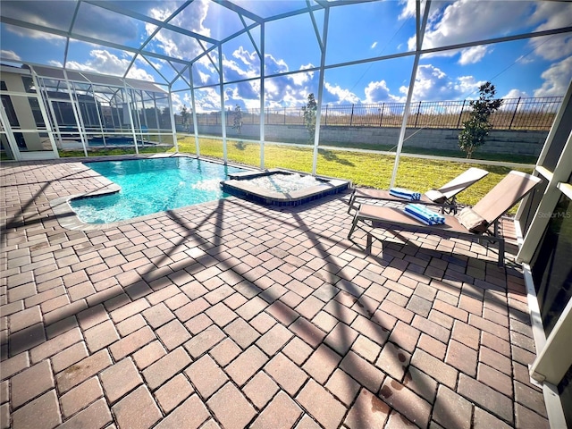 outdoor pool with a patio, fence, a lawn, and a lanai