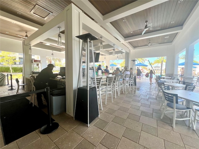 view of patio featuring outdoor dining area and a ceiling fan