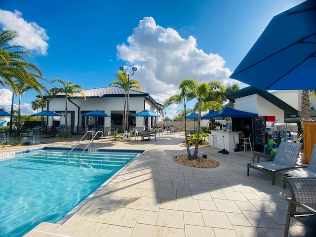 pool featuring fence and a patio area