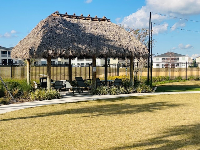 surrounding community with a gazebo, a lawn, and fence