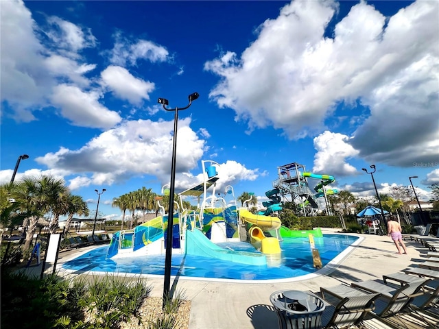 view of swimming pool with playground community