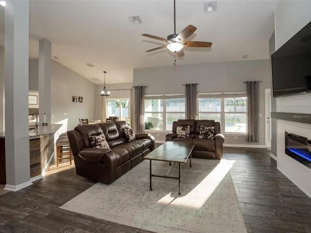 living room featuring visible vents, a healthy amount of sunlight, and vaulted ceiling