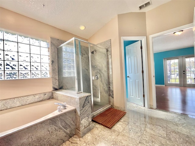 bathroom with visible vents, a shower stall, a garden tub, french doors, and a textured ceiling