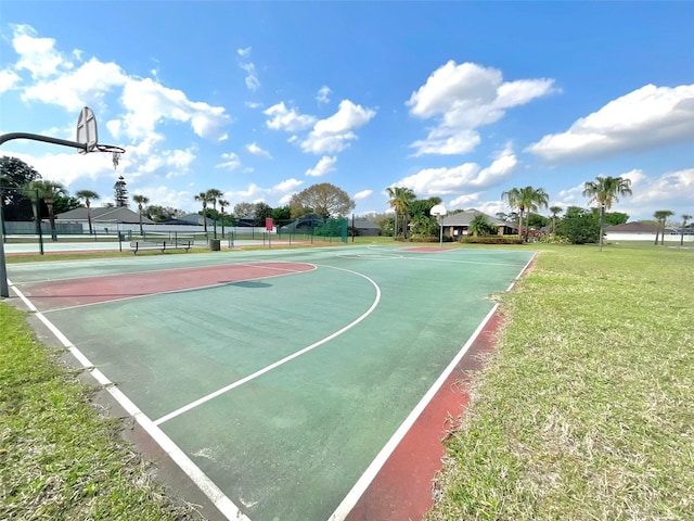 view of basketball court with community basketball court and a yard