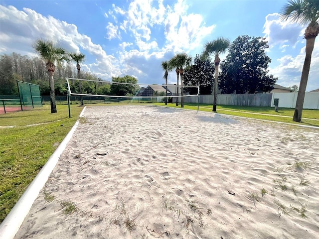 view of community with a yard, fence, and volleyball court