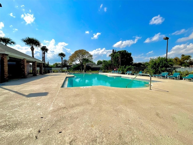 pool featuring a patio and fence