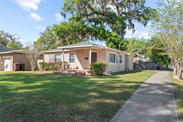 view of front of home with a front yard and fence