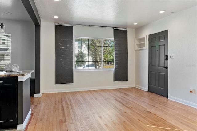 entryway featuring recessed lighting, light wood-style floors, and baseboards