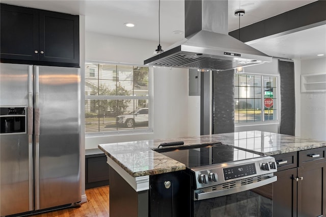 kitchen featuring a kitchen island, light stone counters, light wood-style floors, island range hood, and stainless steel appliances