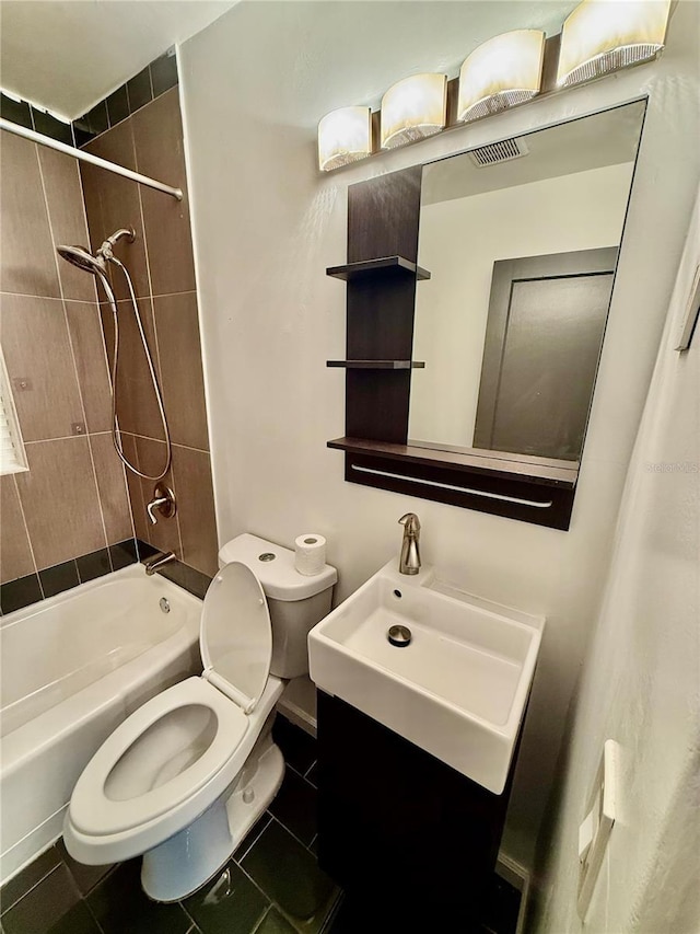 bathroom with tile patterned floors, shower / bath combination, toilet, and a sink