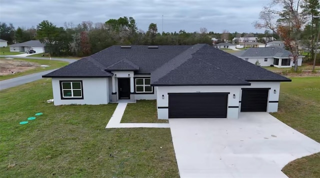 view of front of property featuring stucco siding, a front lawn, concrete driveway, an attached garage, and a shingled roof