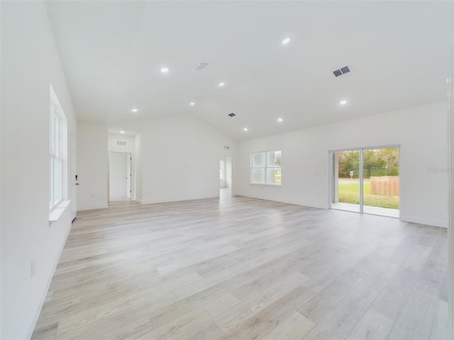 unfurnished living room featuring light wood-type flooring, visible vents, recessed lighting, baseboards, and lofted ceiling