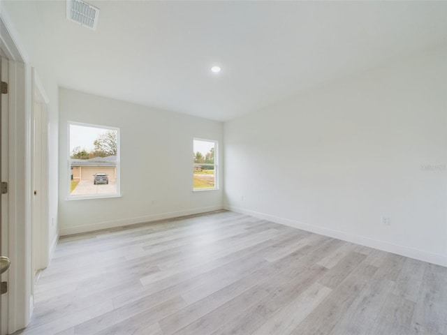 unfurnished room with recessed lighting, visible vents, baseboards, and light wood finished floors