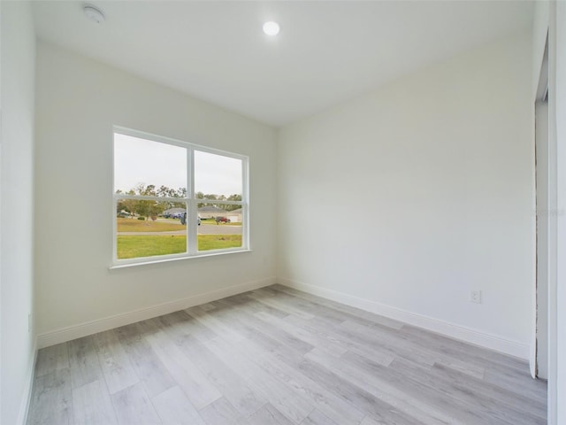 spare room with recessed lighting, baseboards, and light wood-style floors