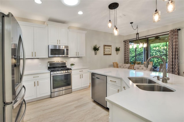 kitchen with a sink, light countertops, white cabinetry, and stainless steel appliances