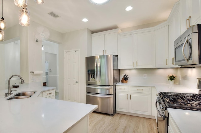 kitchen with white cabinetry, visible vents, appliances with stainless steel finishes, and a sink