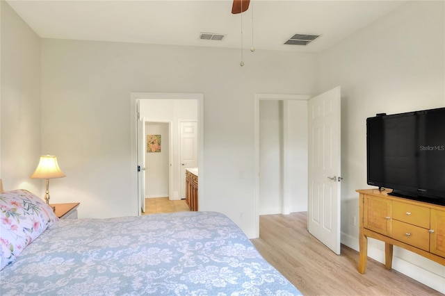 bedroom with visible vents, baseboards, and light wood finished floors