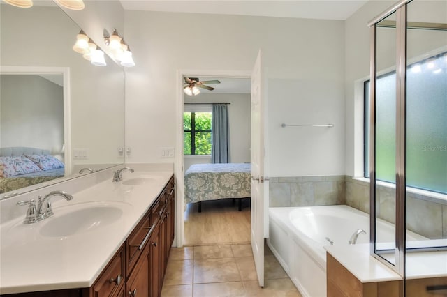 ensuite bathroom featuring a sink, ensuite bathroom, and tile patterned flooring