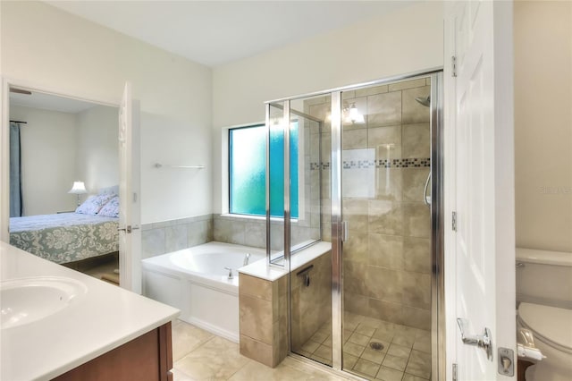 bathroom with vanity, a stall shower, ensuite bathroom, a garden tub, and toilet