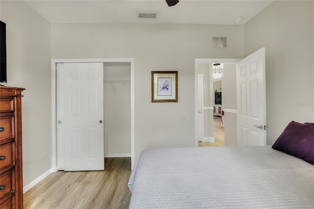 bedroom with a closet, visible vents, baseboards, and light wood-style floors