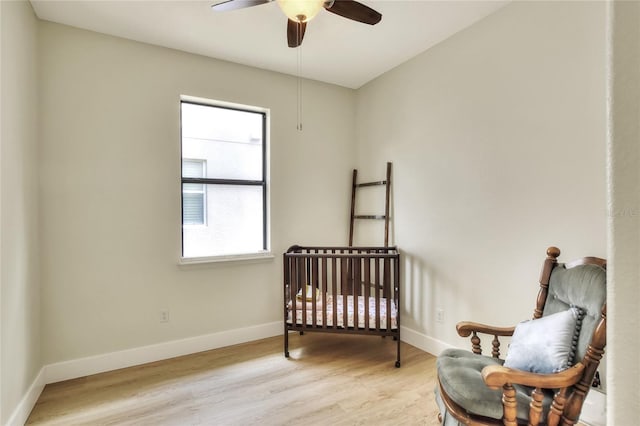 bedroom with baseboards, wood finished floors, and a ceiling fan