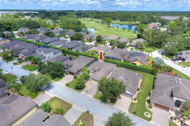 birds eye view of property with view of golf course, a water view, and a residential view