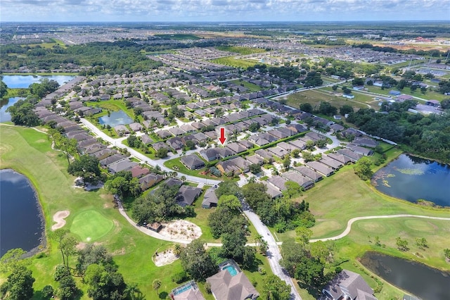 aerial view with a residential view, a water view, and golf course view