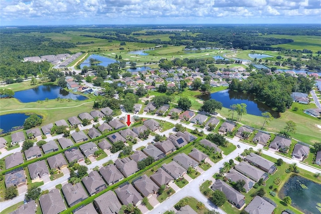 birds eye view of property featuring view of golf course, a water view, and a residential view