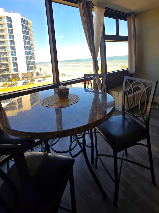 dining room featuring a water view and wood finished floors