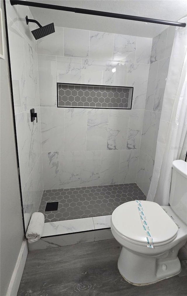 bathroom with toilet and a shower stall