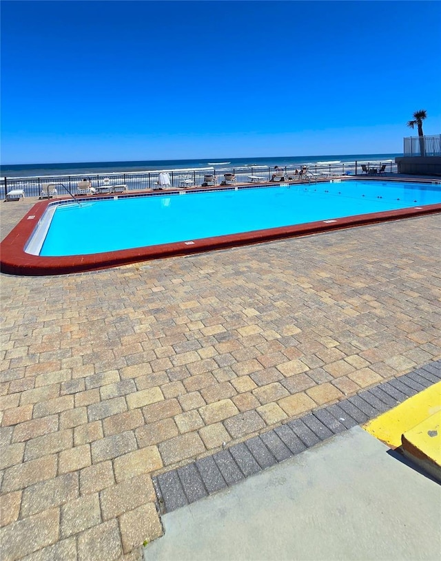 view of swimming pool with a water view