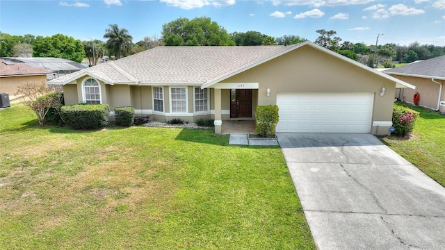 ranch-style home featuring an attached garage, central AC, stucco siding, concrete driveway, and a front lawn