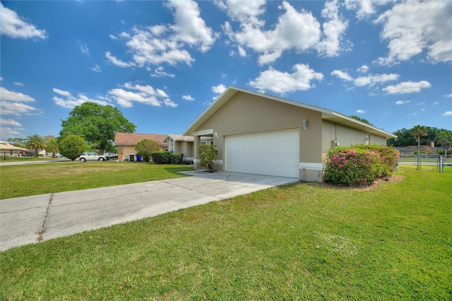 exterior space featuring stucco siding, driveway, a front lawn, and an attached garage