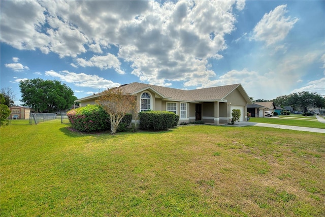 single story home featuring a front lawn, fence, stucco siding, driveway, and an attached garage