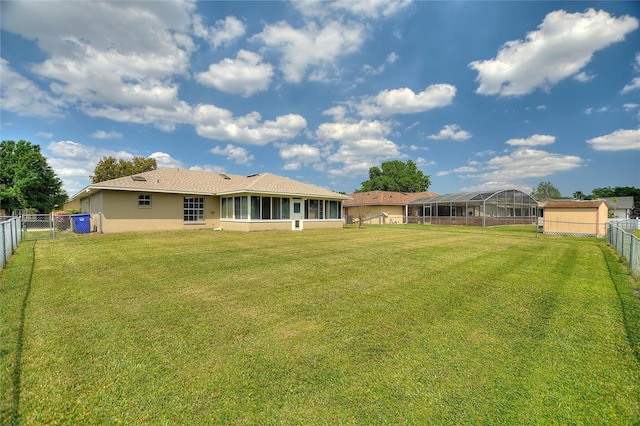 view of yard featuring a fenced backyard and a sunroom