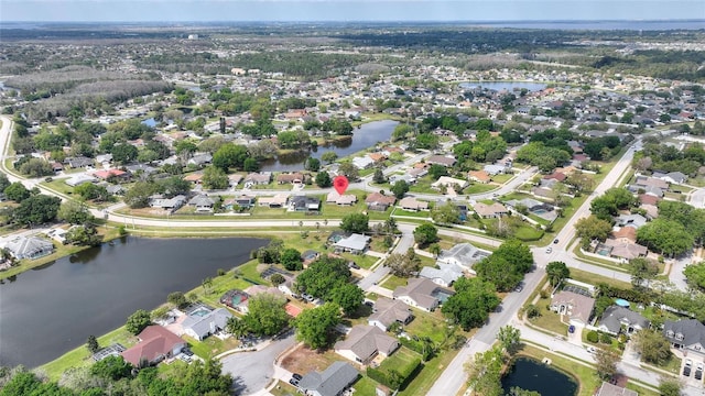 birds eye view of property featuring a water view and a residential view