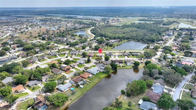 birds eye view of property with a water view and a residential view