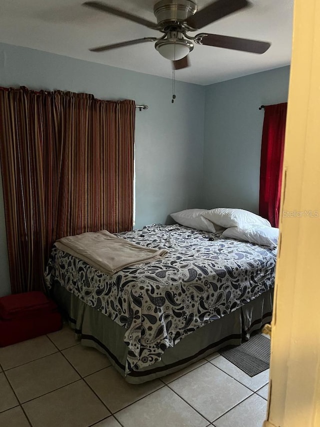 bedroom with light tile patterned floors and ceiling fan