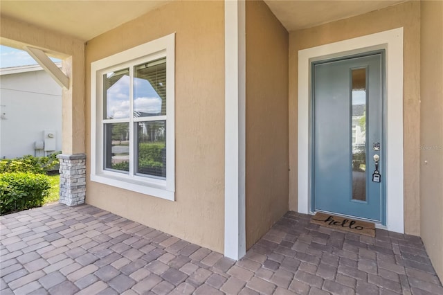 view of exterior entry featuring stucco siding