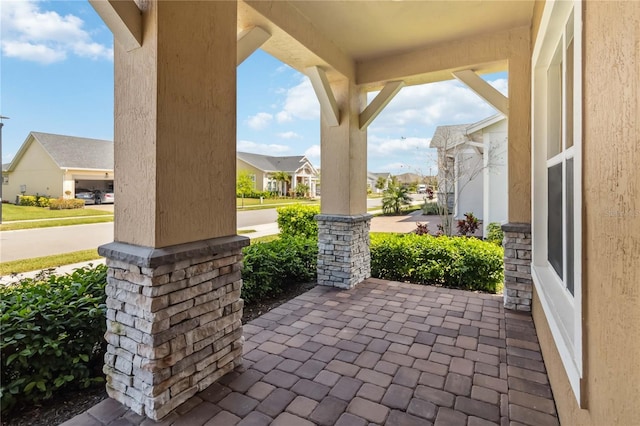 view of patio with a residential view and a porch